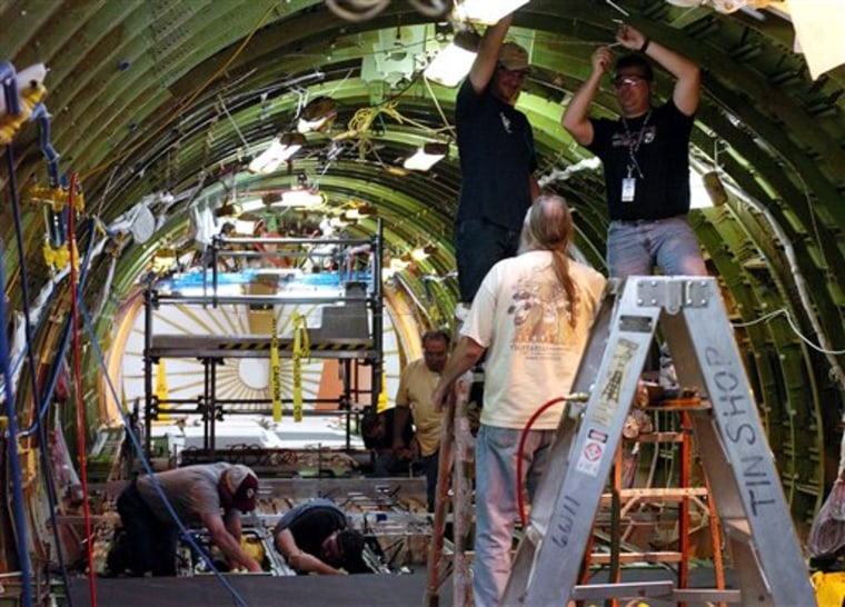 Boeing employees do modification work on the upper portion of a Boeing KC-767 tanker being modified for Italy at the plant in Wichita, Kan.